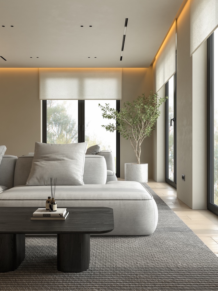 styl japandi - szara sofa i czarny stolik na dywanie obok okien 